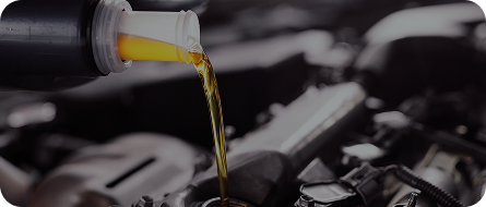 Oil being poured into a car engine. | GenAuto