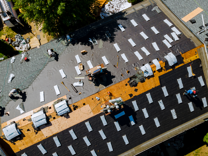 An aerial view of a roof being installed on a house.