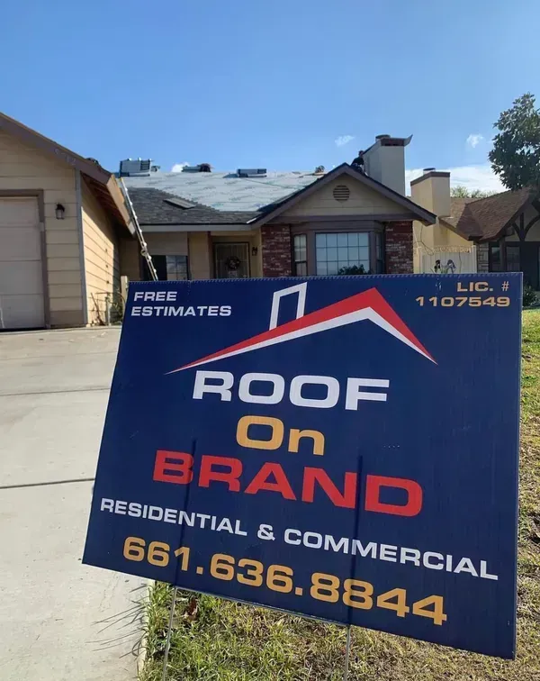 A roof on brand sign in front of a house in Bakersfield, CA