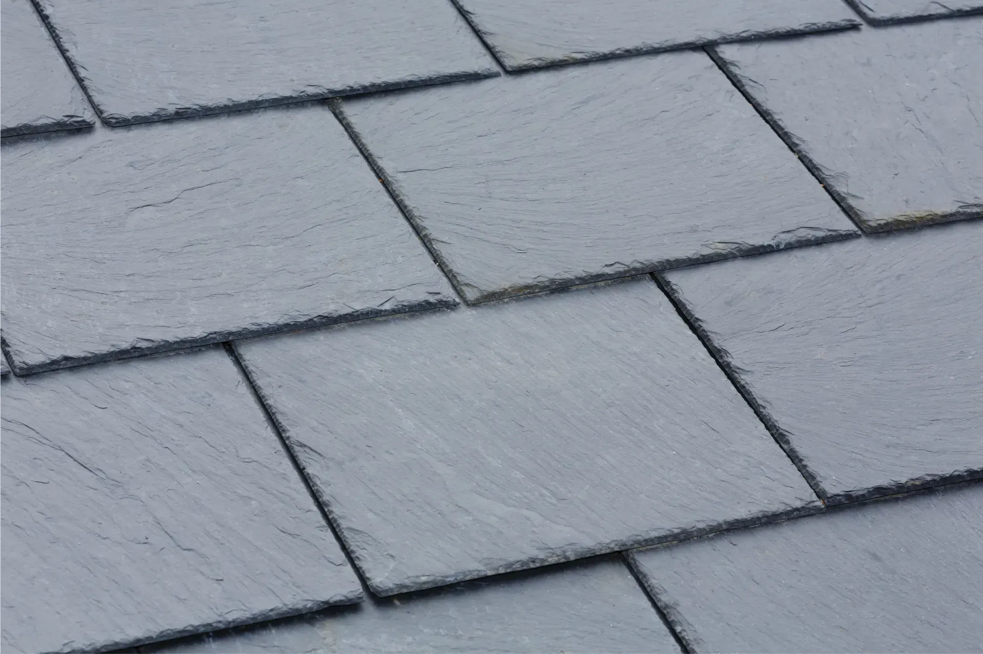 A close up of a roof made of slate tiles.