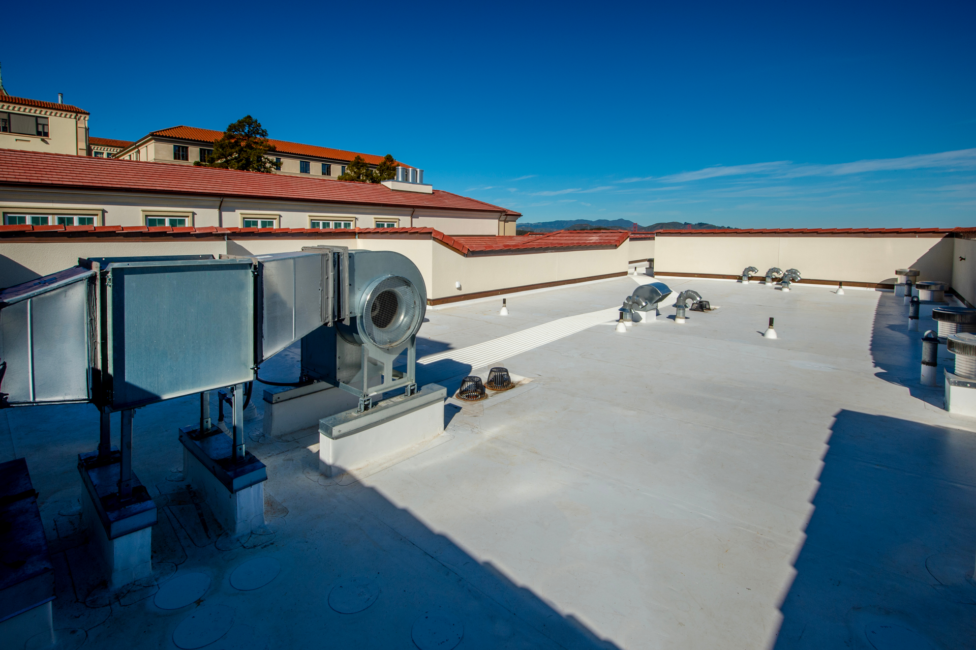 The roof of a building with a lot of ventilation equipment on it.