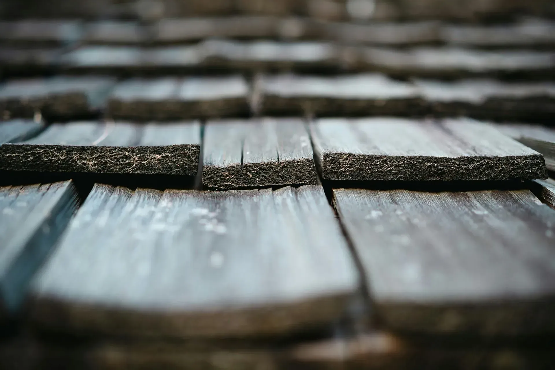 A close up of a wooden roof with shingles.