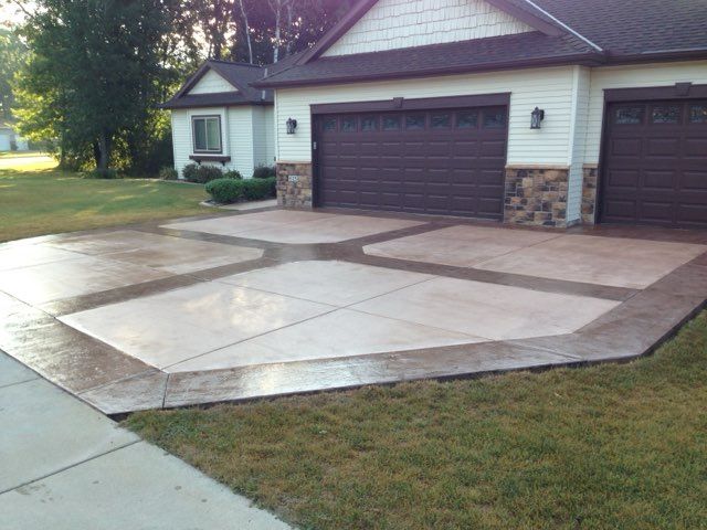Person smoothing wet concrete with a trowel in a bright indoor space