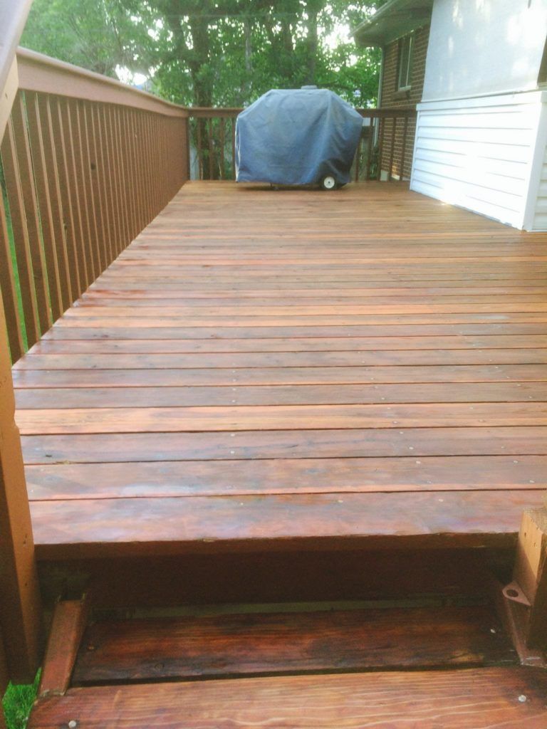 a wooden deck with a grill on top of it .