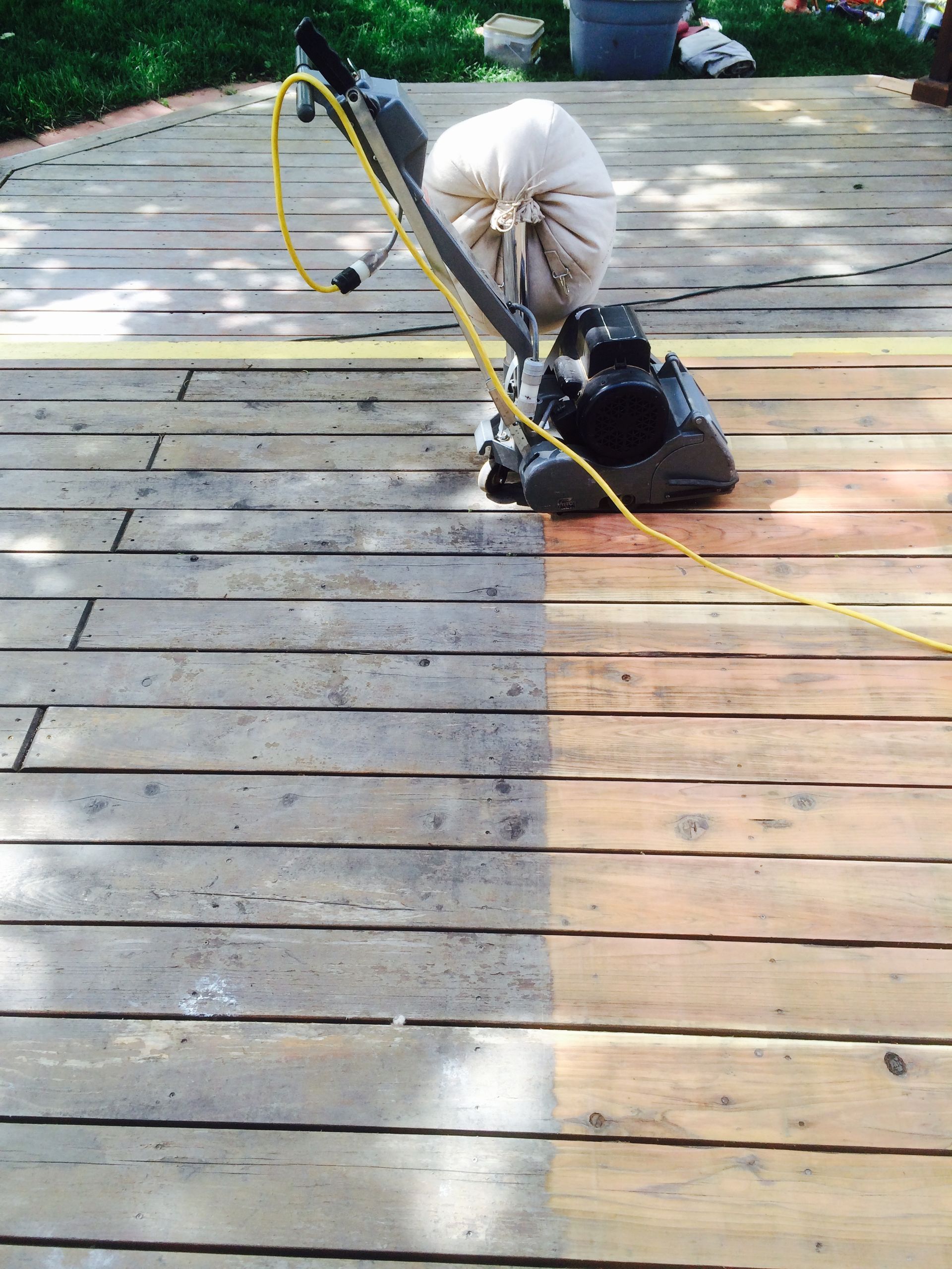 a machine is being used to clean a wooden deck
