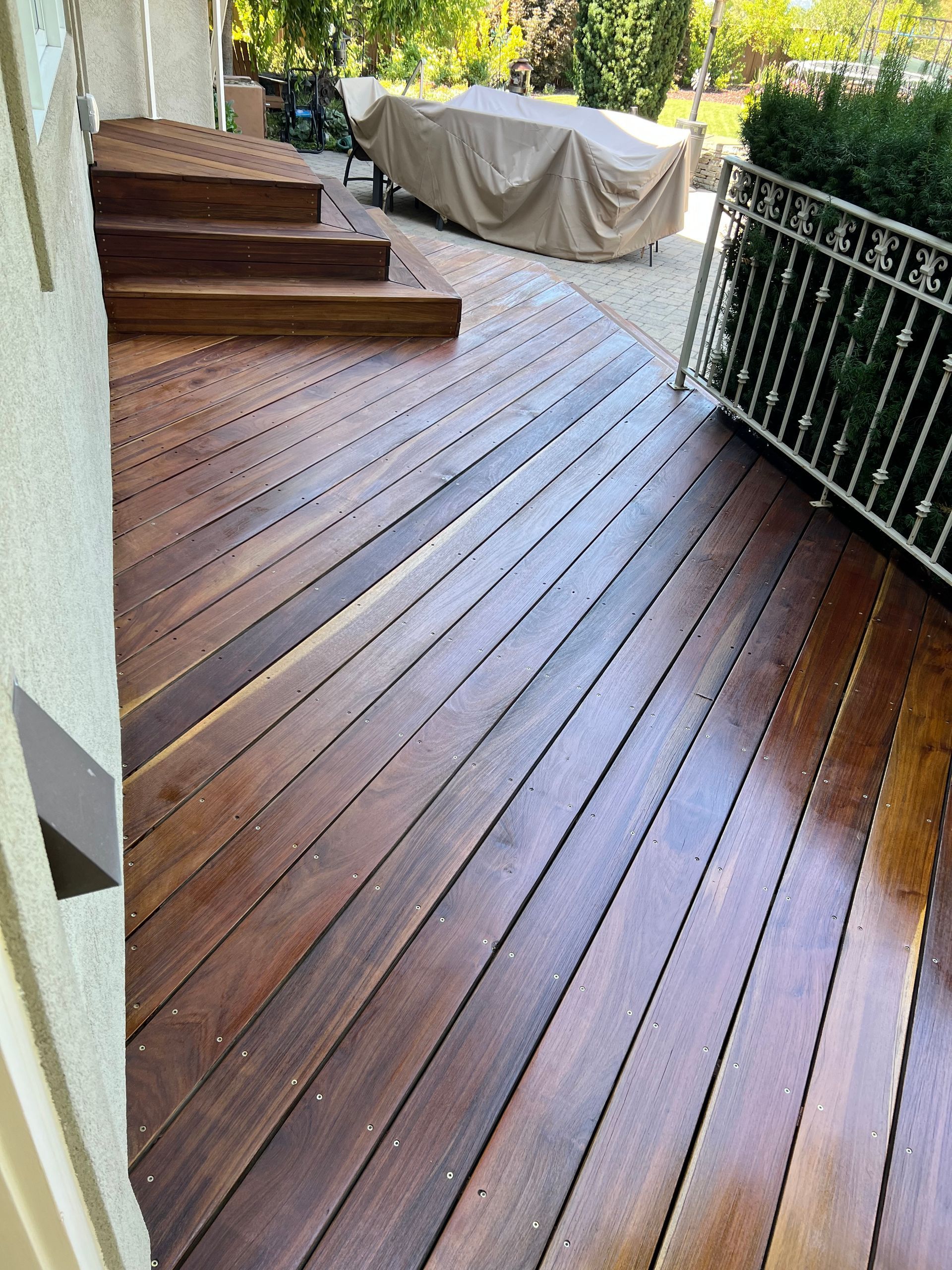 a wooden deck with stairs leading up to it .