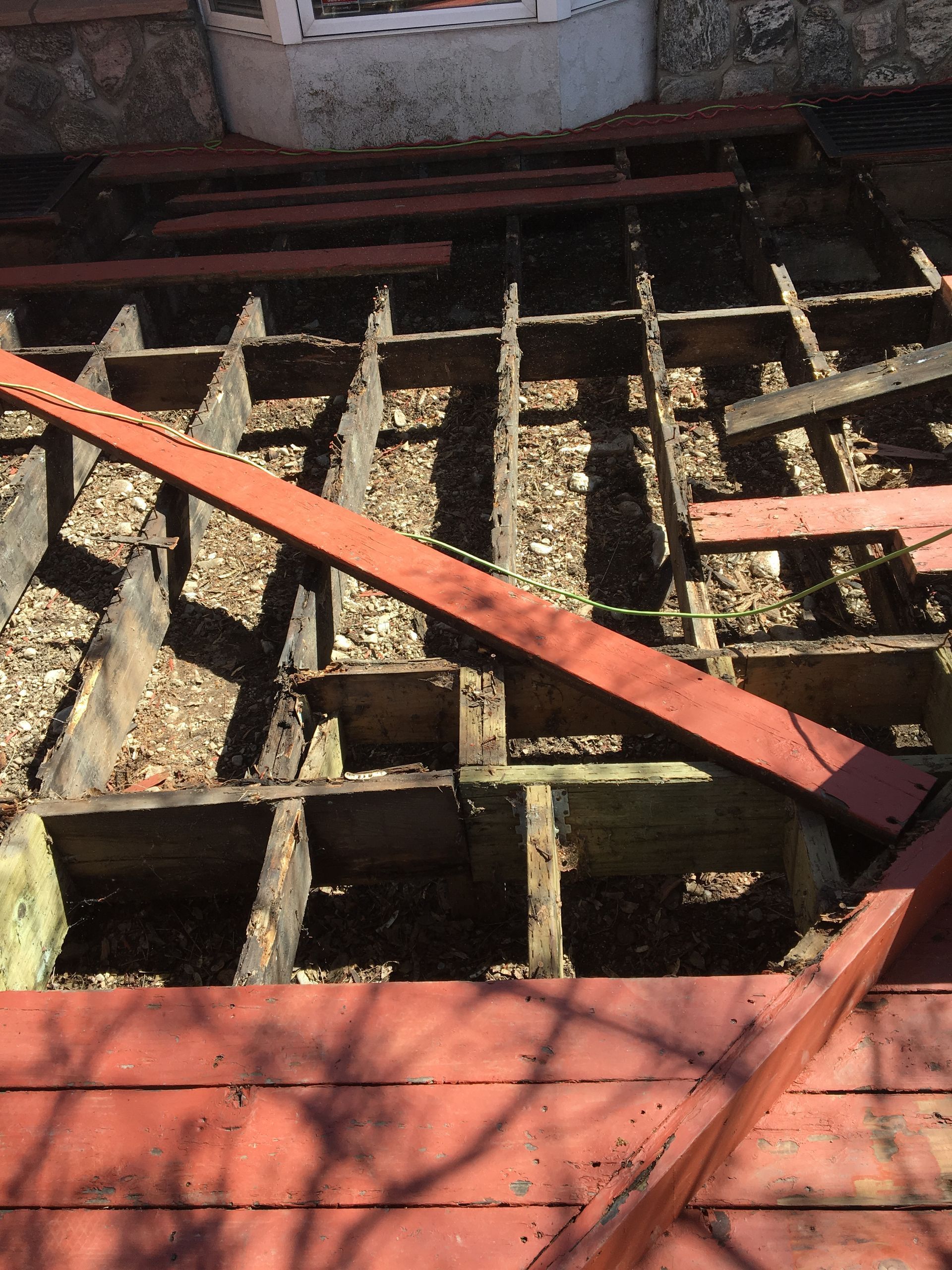 a wooden deck with a few pieces of wood missing