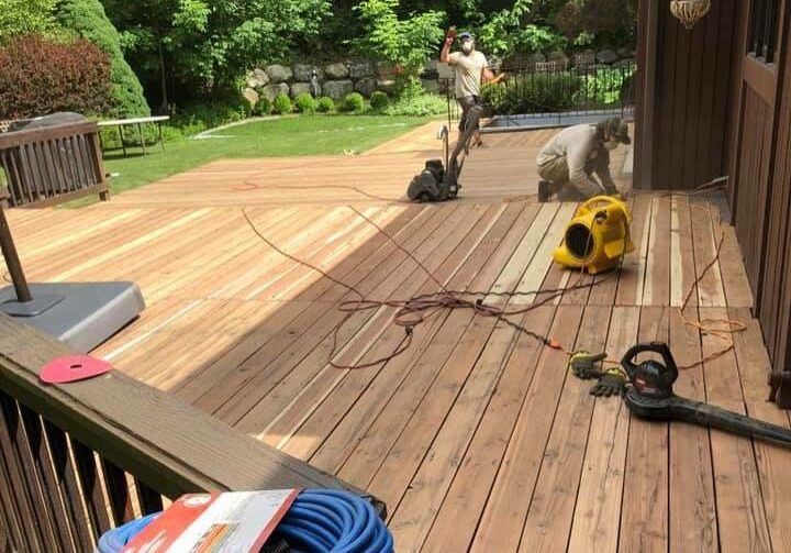 a wooden deck is being built in a backyard .