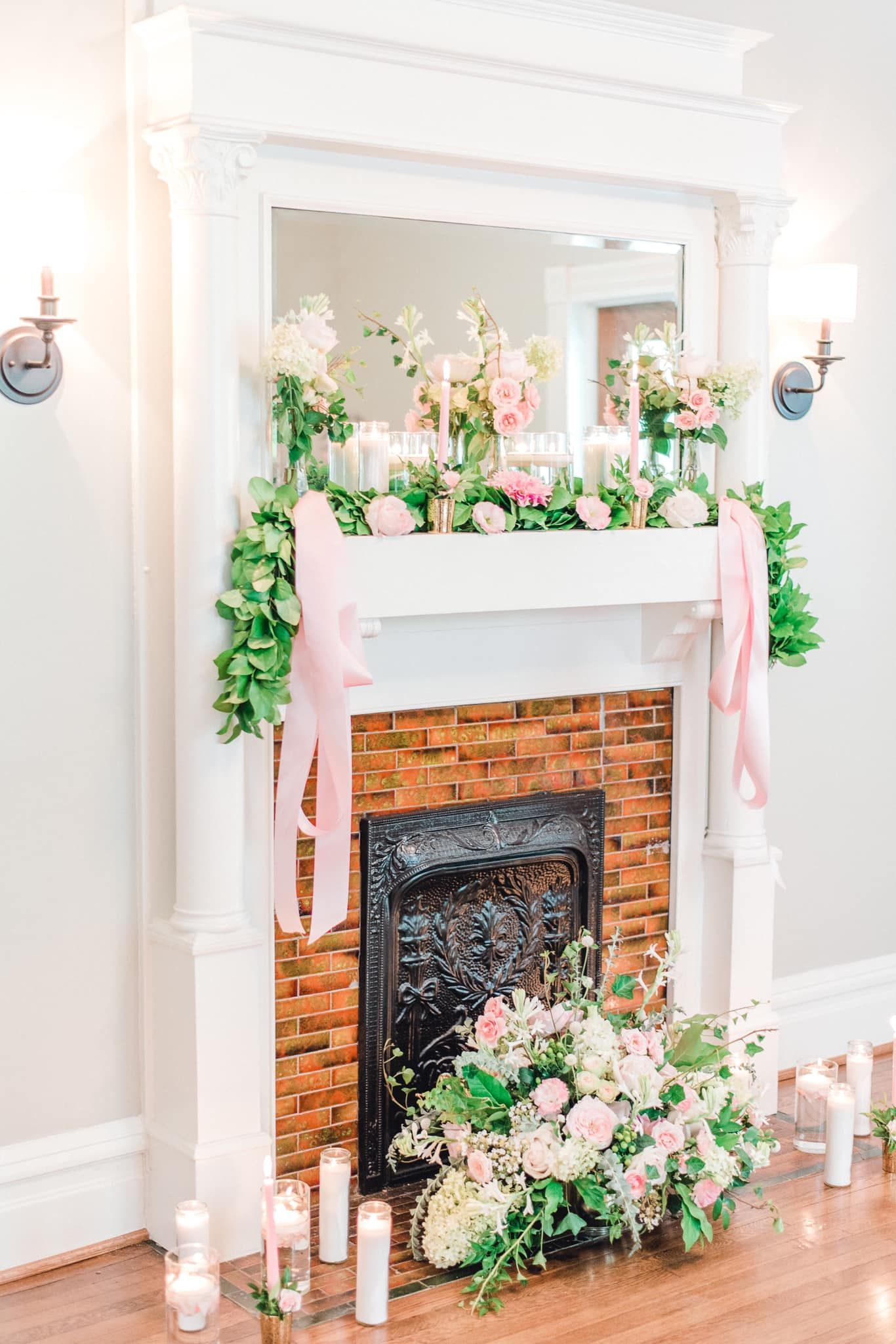 floral garland on fireplace mantel at wedding venue