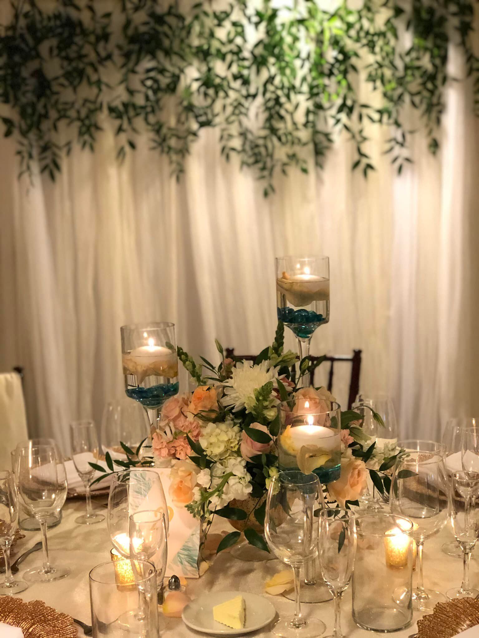 floral centerpiece with candles at wedding