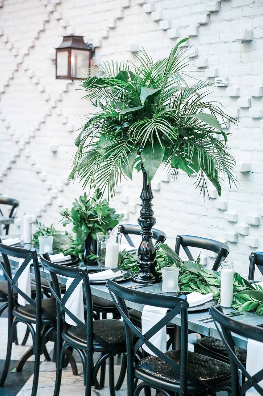tropical greenery and garland on table