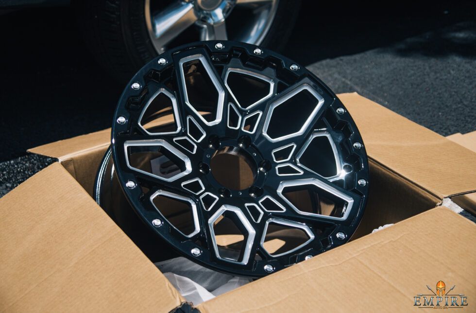 A black and white wheel is sitting in a cardboard box.