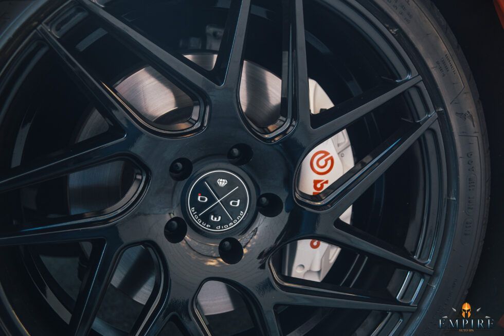 A close up of a car wheel with a brembo brake.