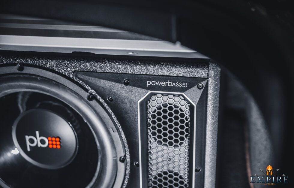 A close up of a subwoofer in a car.