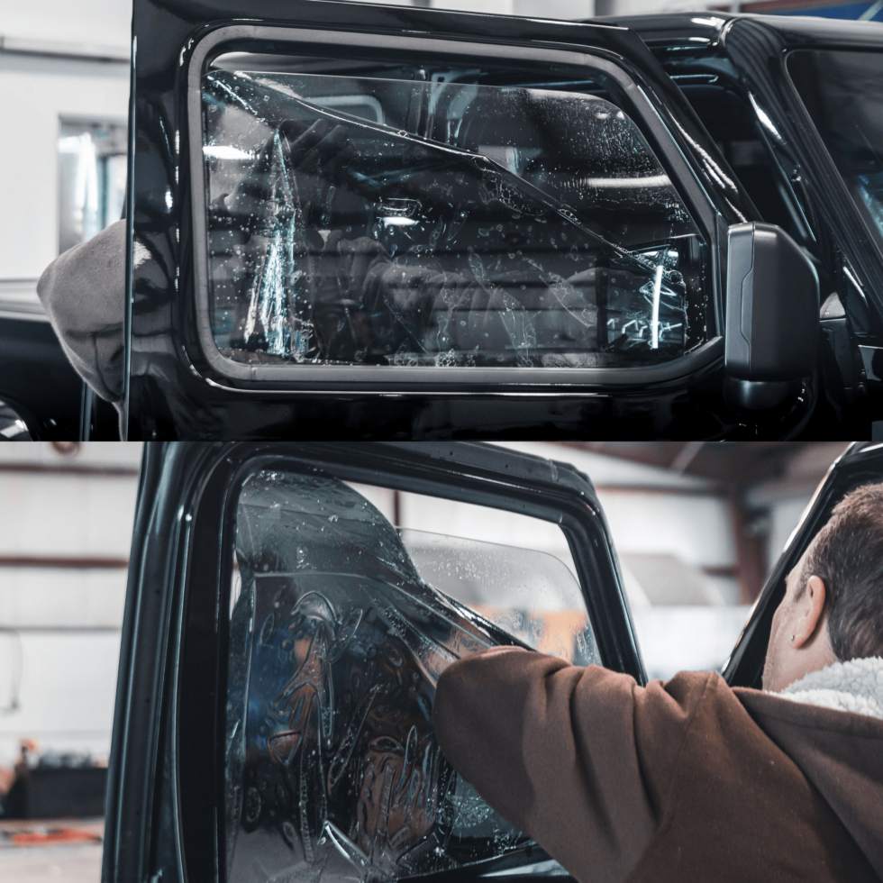 A man is installing window tinting on a black truck