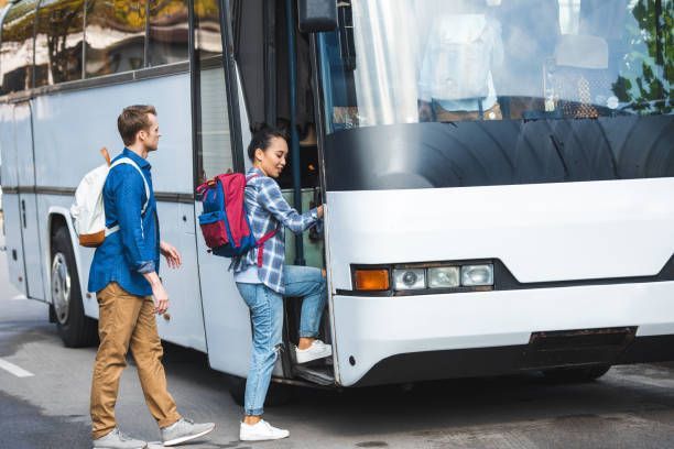 Tourists boarding a street bus, highlighting professional charter bus transportation for groups.
