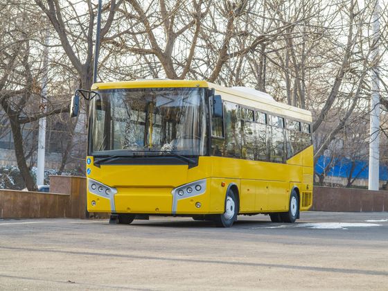 A yellow charter bus designed for transporting passengers and schoolchildren.