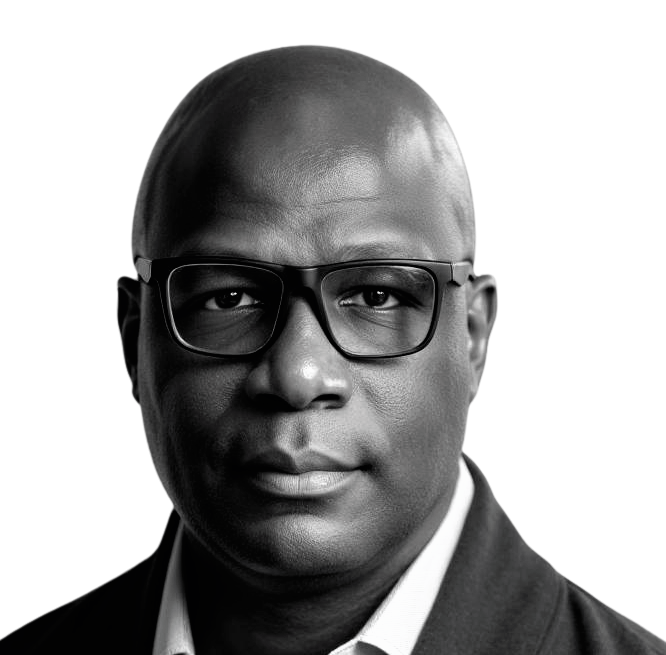 A bald man wearing glasses and a black shirt is looking at the camera.