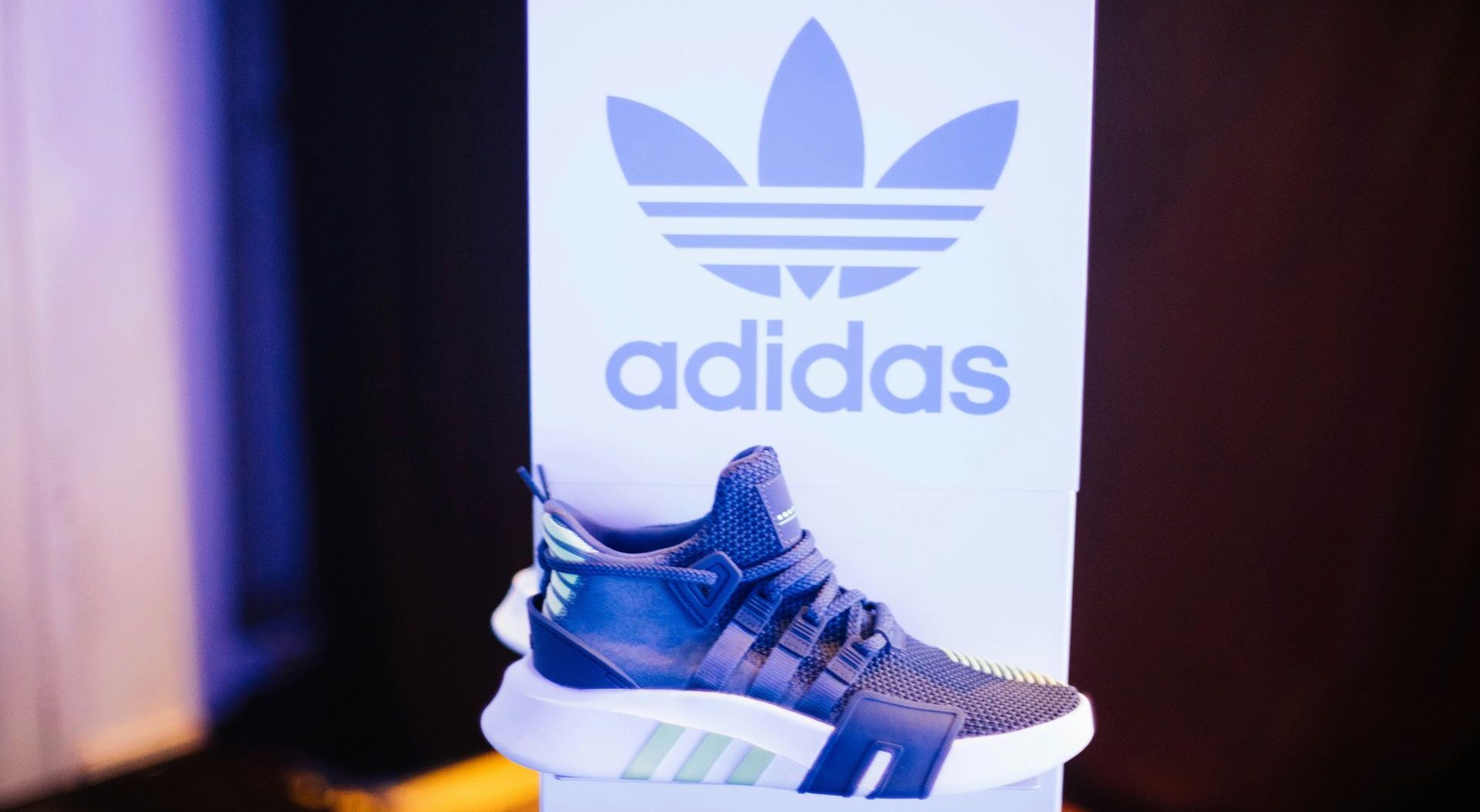 A picture of a shoe on a sign that says adidas