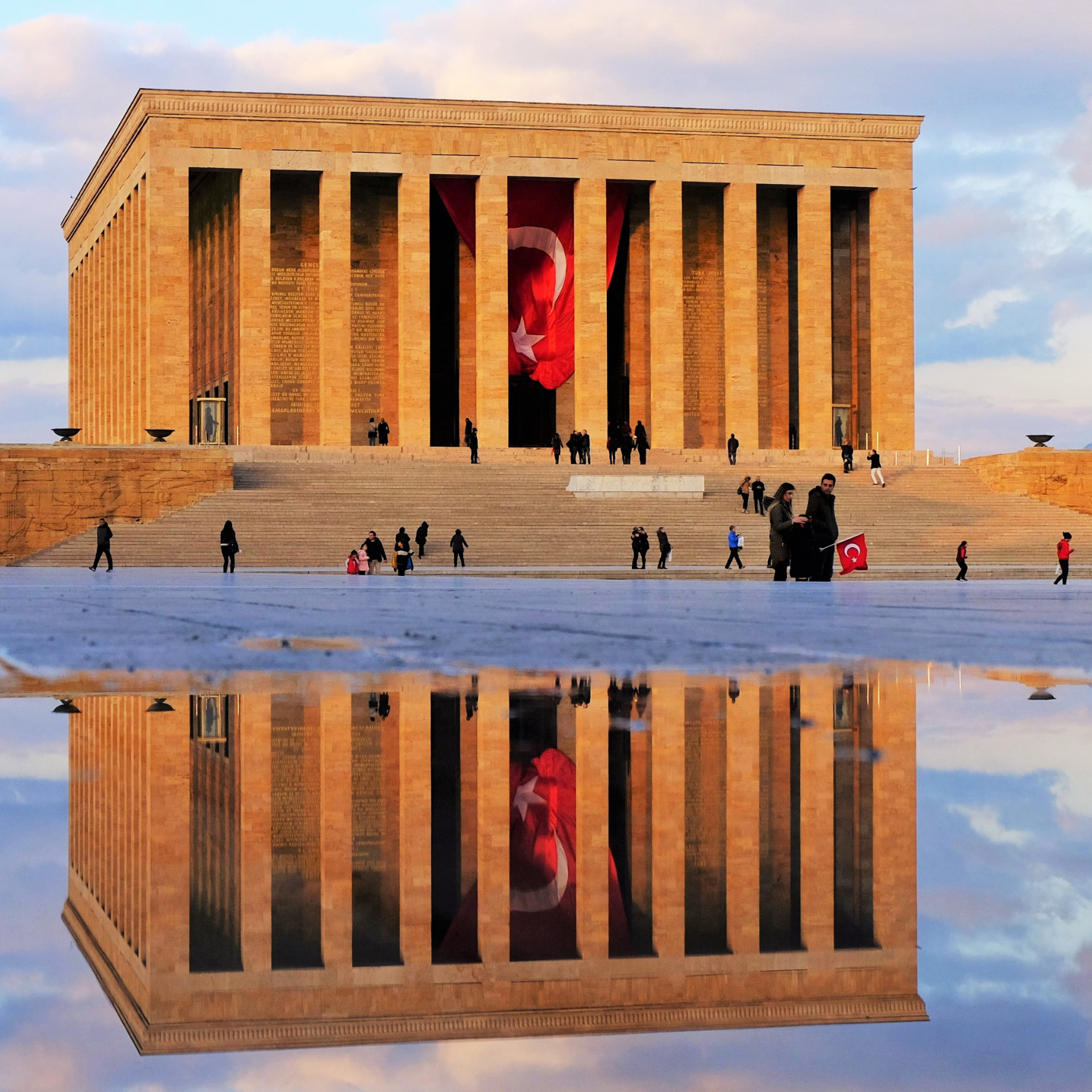 A reflection of a building in a puddle of water