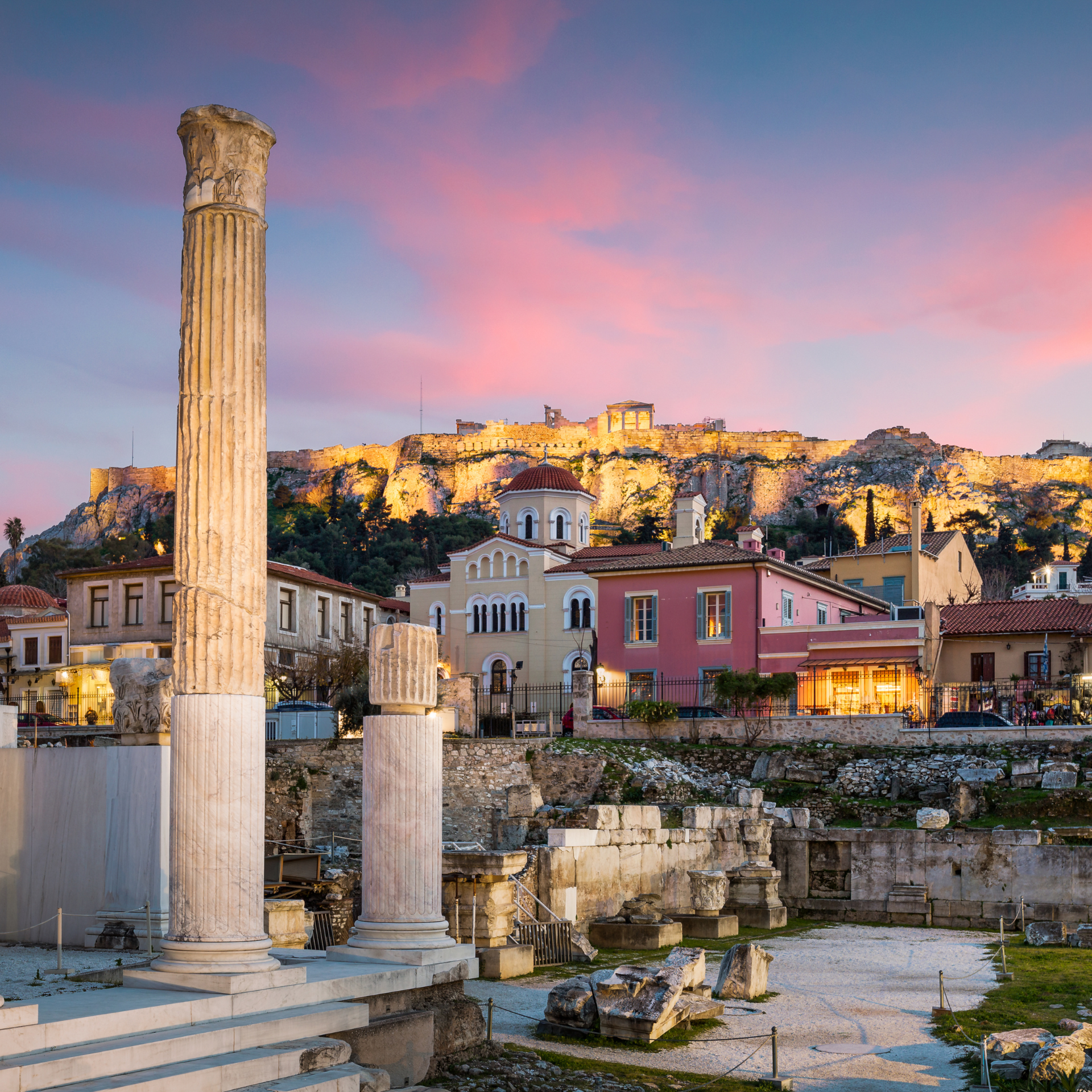 A city with a castle in the background and a pillar in the foreground
