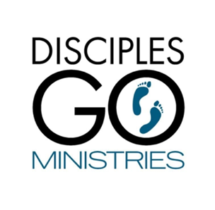 Children in colorful chairs, classroom setting, with teachers, red building.