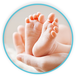 a person is holding a baby's feet in their hands