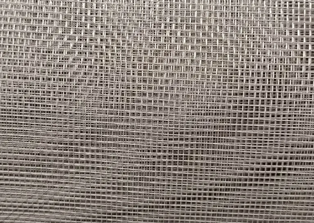 Close-up of a silver-colored wire mesh with a grid pattern. Close-up of a silver-colored wire mesh with a grid pattern.