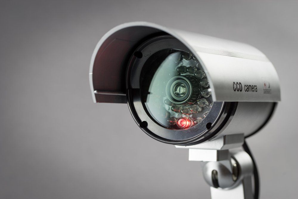 A security camera with a red light on the lens