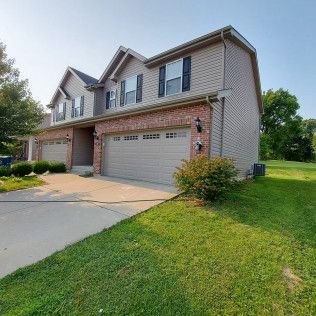 duplex house with lawn outside