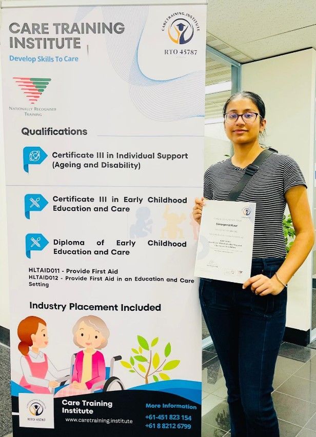 Smiling Black man in a yellow hoodie against a yellow backdrop. He looks to the side with a warm expression.