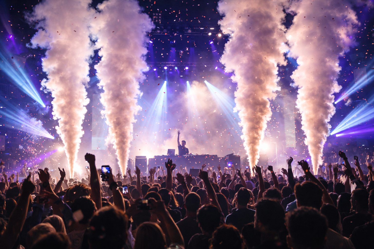Crowd at a concert with raised hands, bright stage lights, and smoke plumes in purple haze
