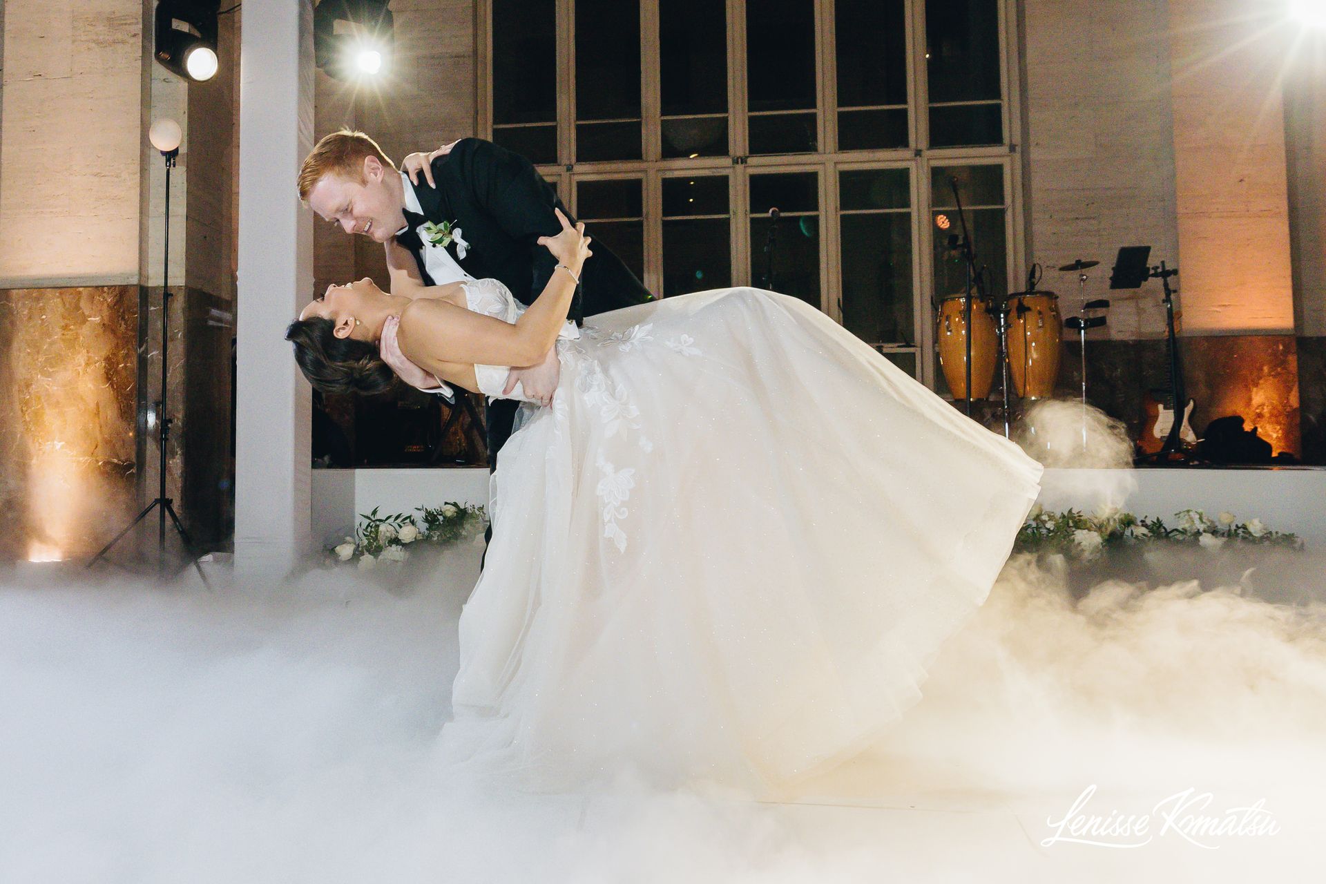 Bride and groom dancing on a cloud during their first dance at a luxury wedding with low-lying fog effect in Florida