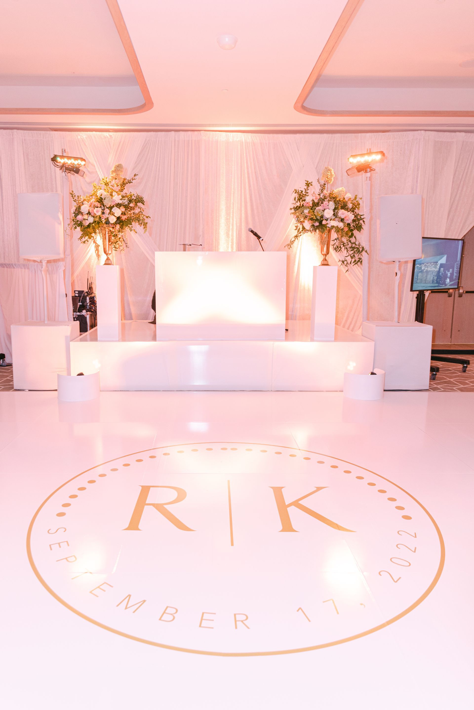 Elegant coastal resort stage with turquoise and gold decor, palm trees, and “COASTAL Resort & Spa” branding