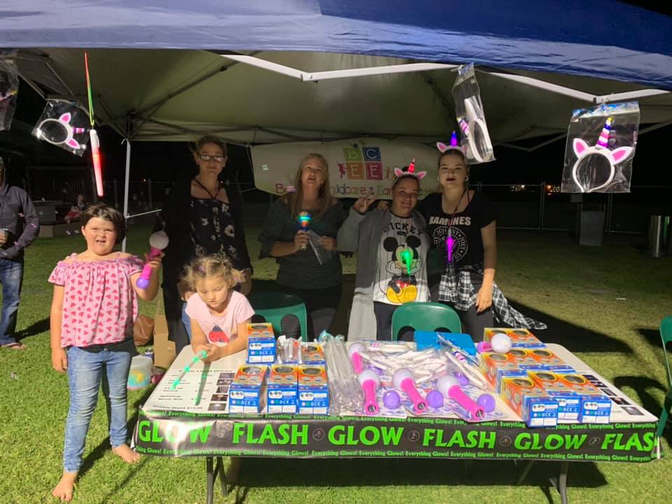 Kids and Adults Behind Stall — Child Care in Bowen, QLD