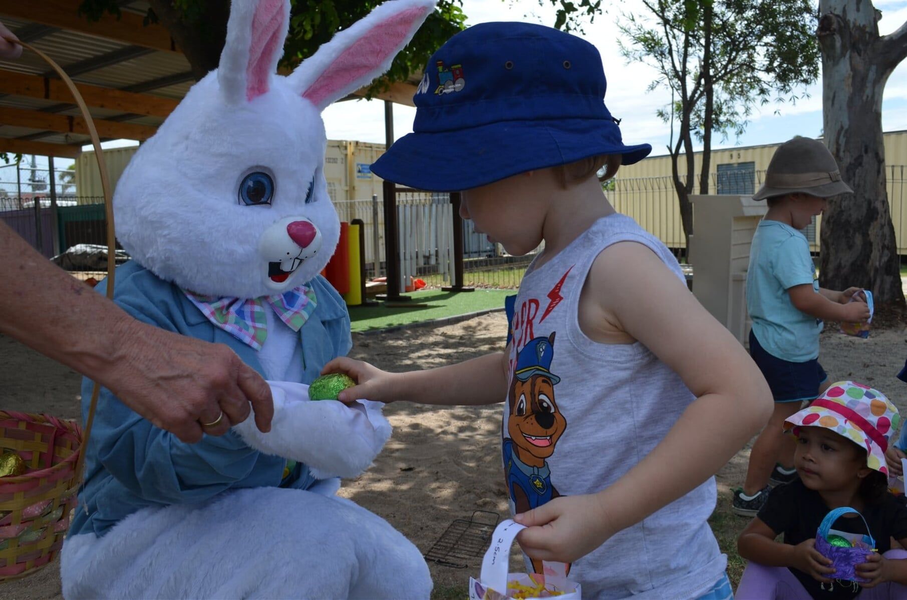 Bunny Giving Kid Easter Egg — Child Care in Bowen, QLD