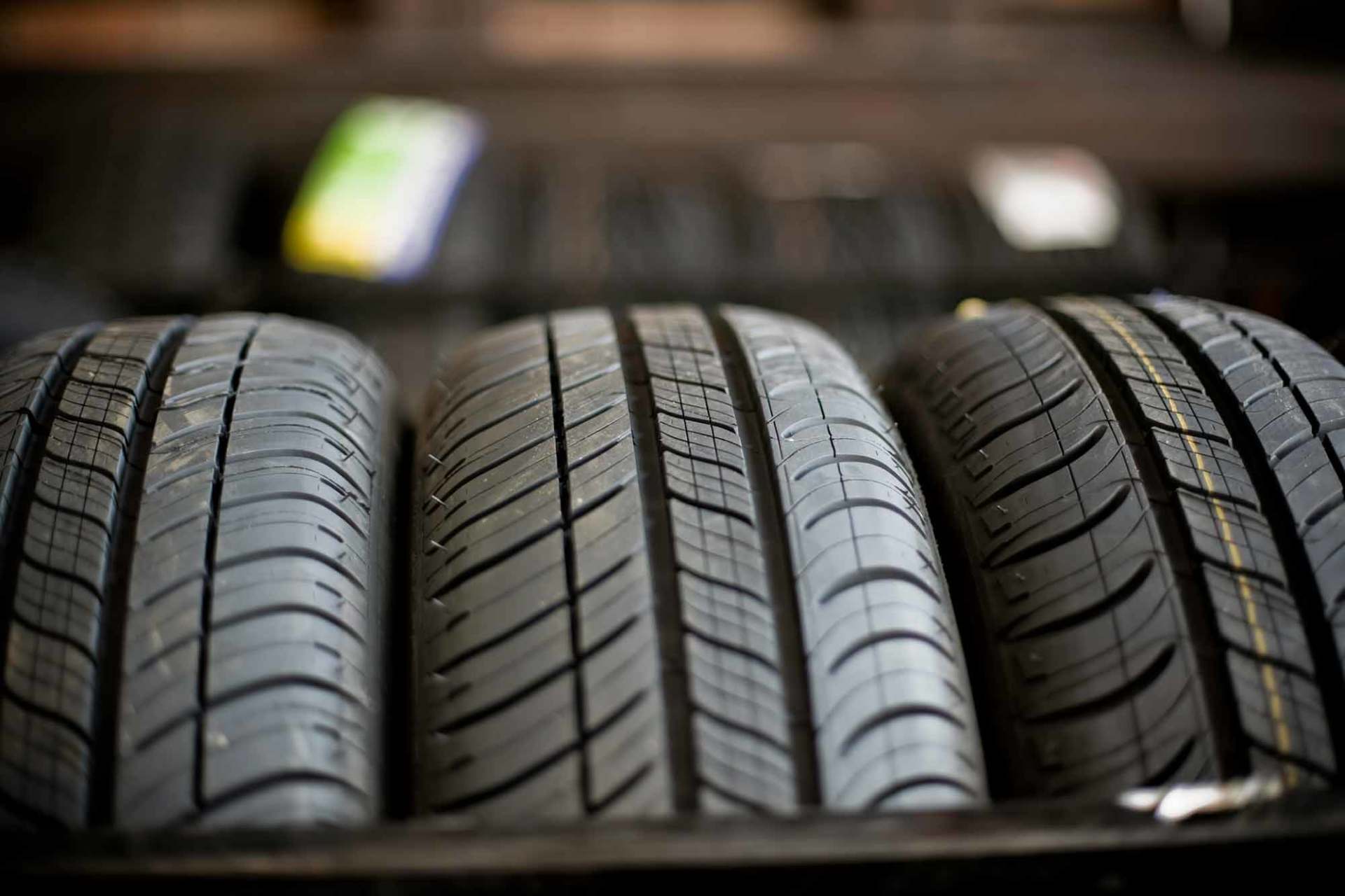 Close-up shot of three tyres in a garage