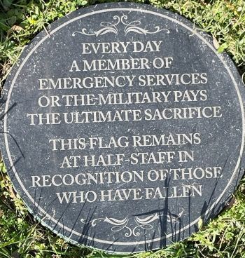 A plaque that says every day a member of emergency services or the military pays the ultimate sacrifice