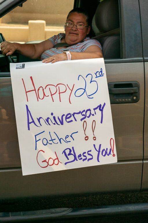 A person in a striped shirt sits in a car.