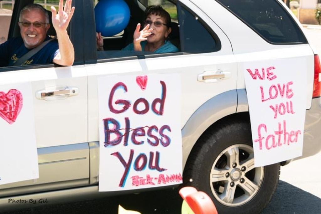 Two smiling passengers wave joyfully.