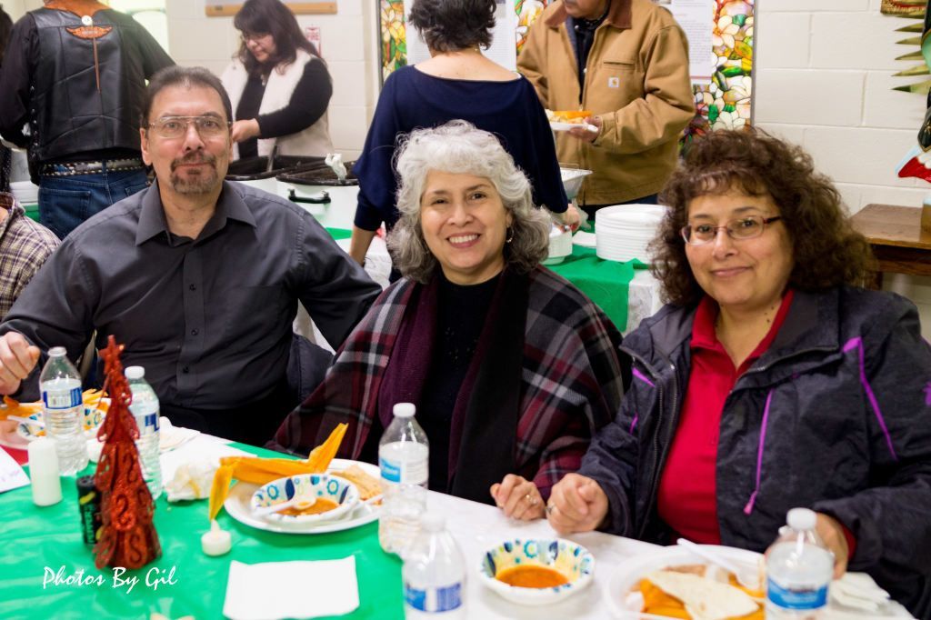 A cheerful group enjoys a meal at a festive gathering.