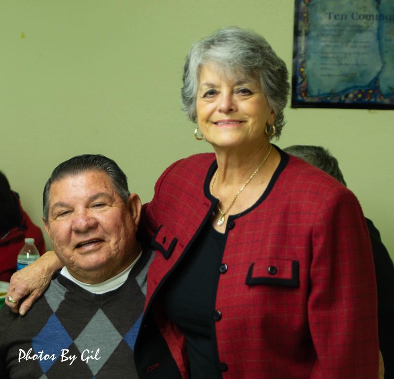 Elderly couple smiling in a room. 