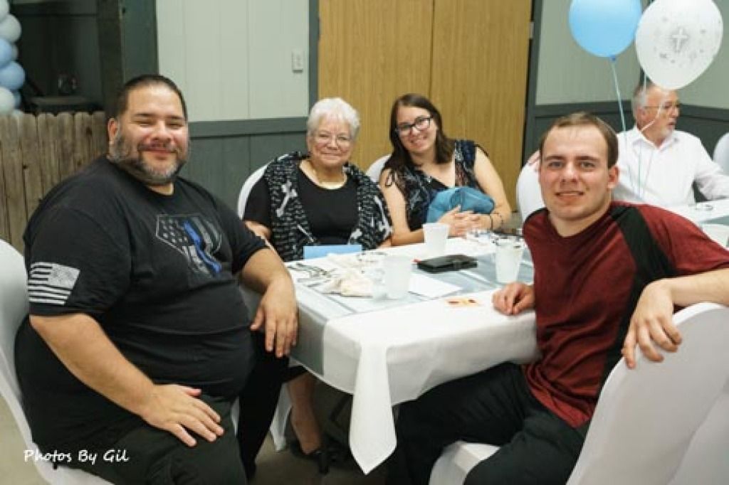 A group at a celebration around a table. 
