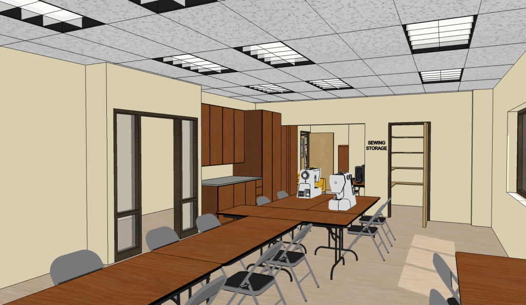 Sewing room with wooden tables, featuring sewing machines and foldable chairs. 