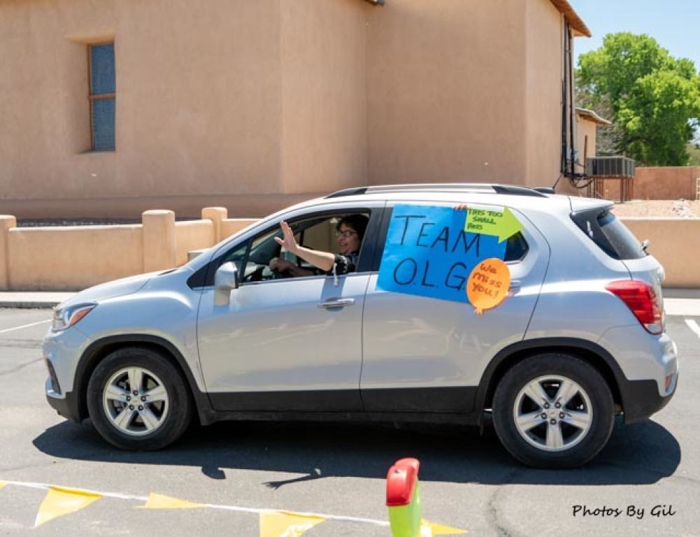 Silver SUV with TEAM OLG sign taped to the side