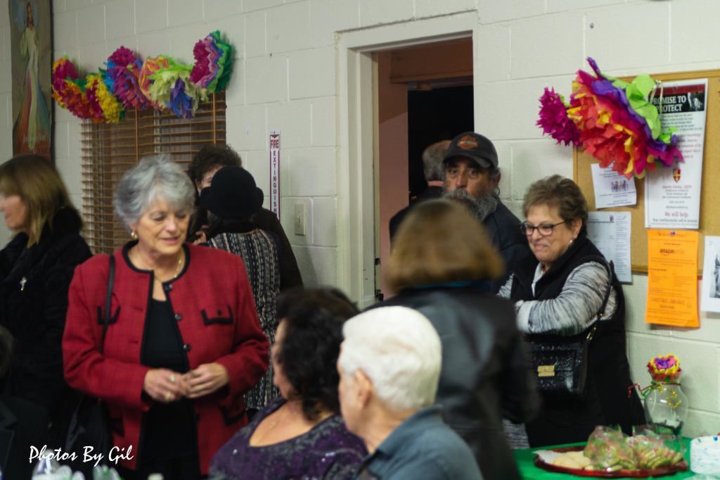 A group of people socializing in a decorated room.