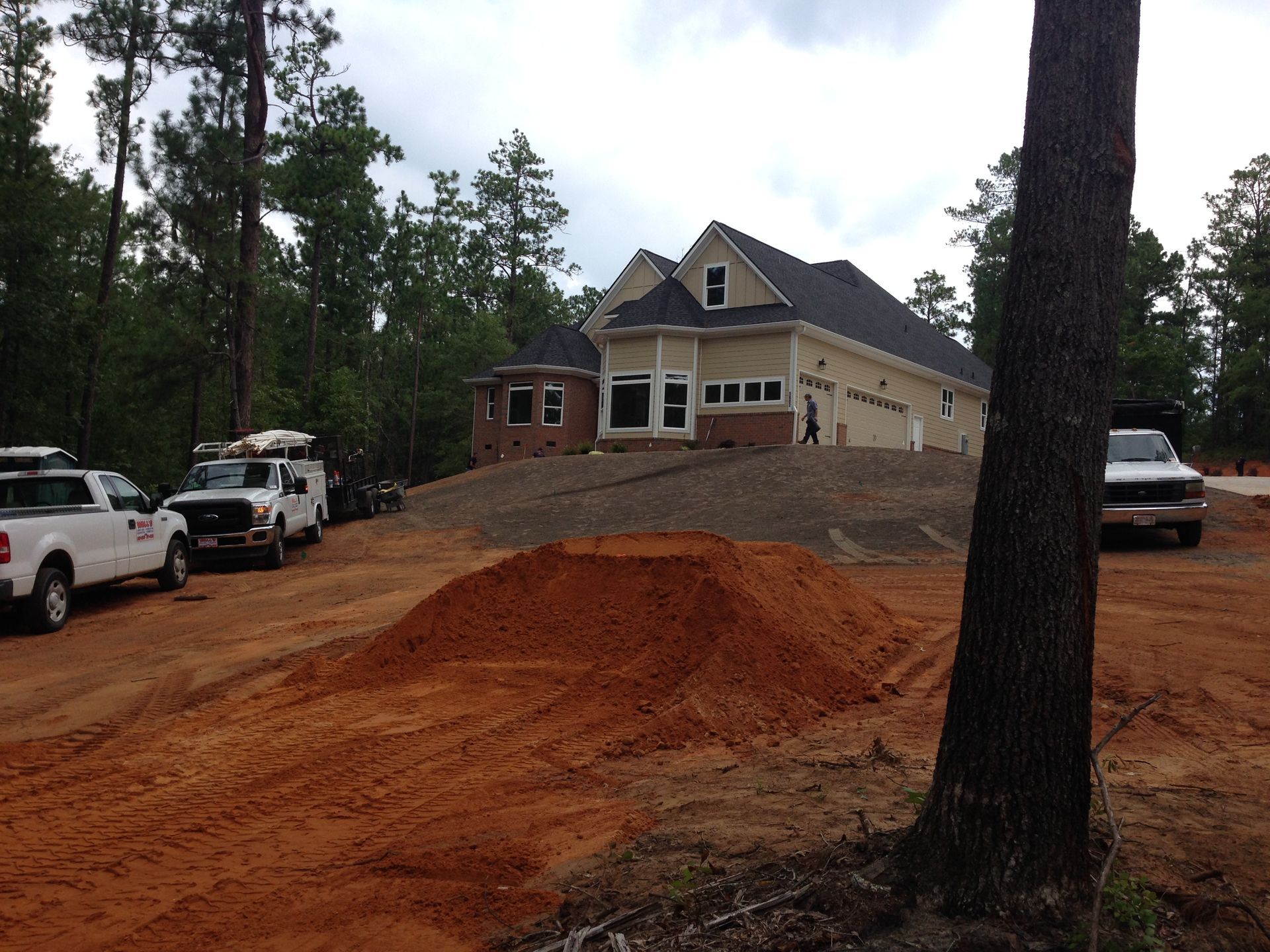 A white truck is parked in front of a house