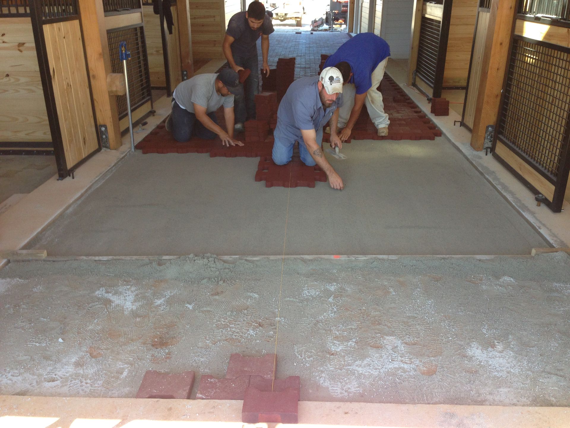 A group of men are working on a concrete floor