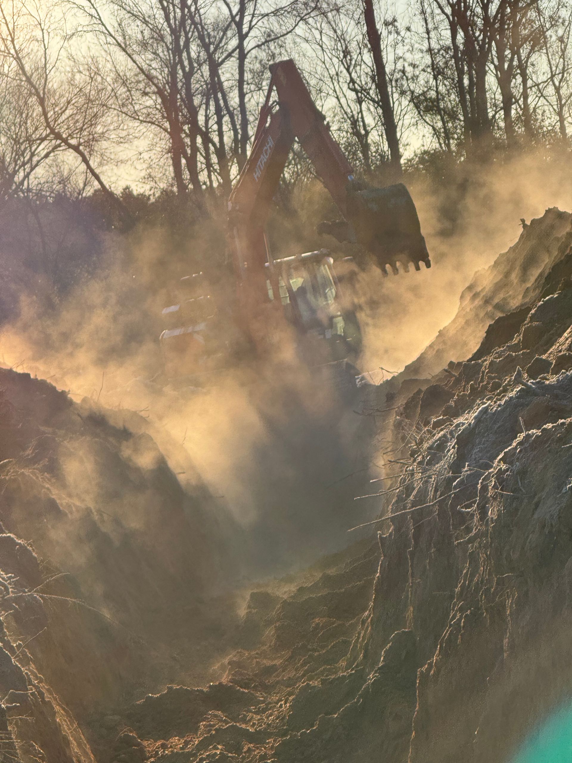 A large excavator is digging a hole in the ground.