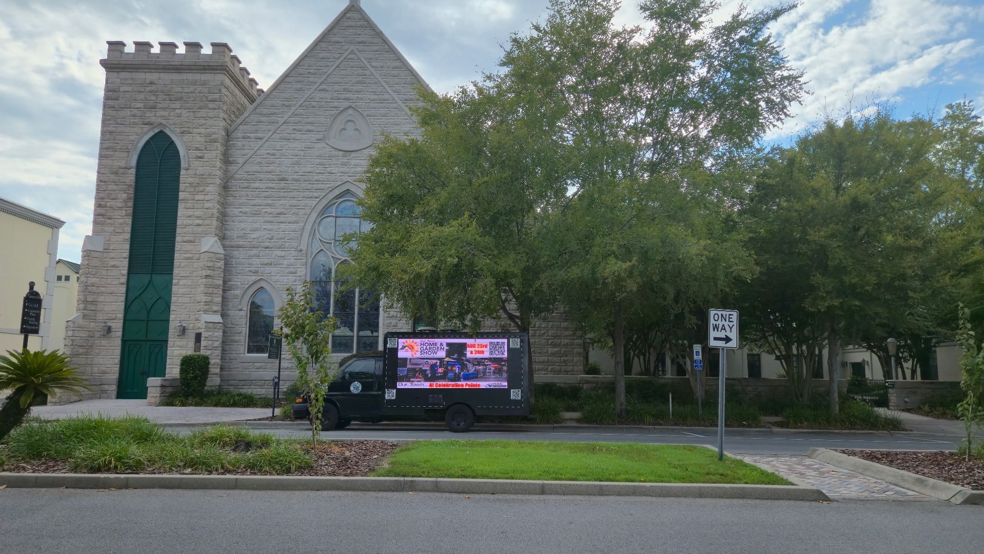 Church exterior with a digital display truck parked in front.